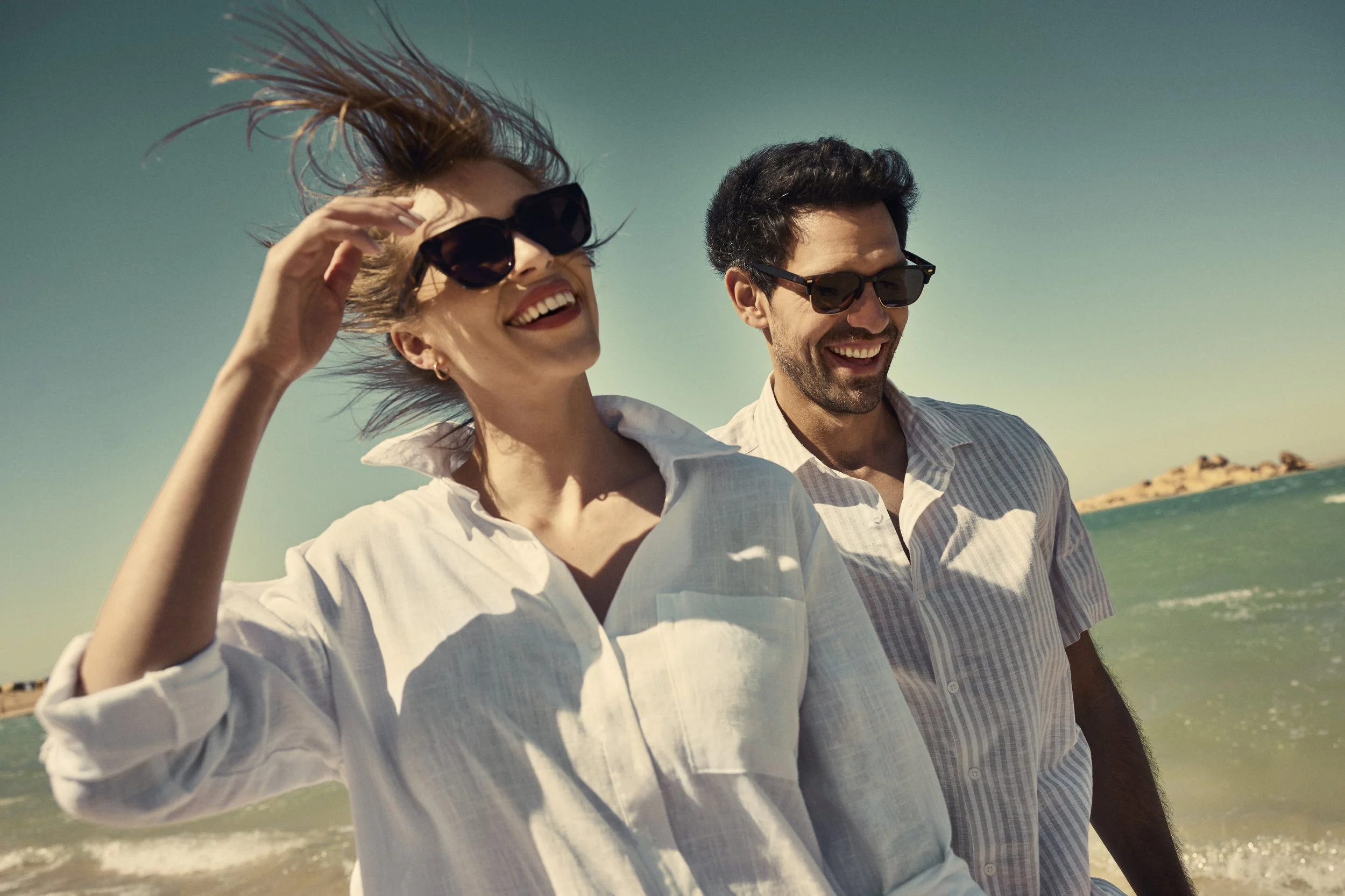 A couple enjoy a walk on the beach - lifestyle image shot for the Saudi Neom project featuring their Red Sea luxury holiday island