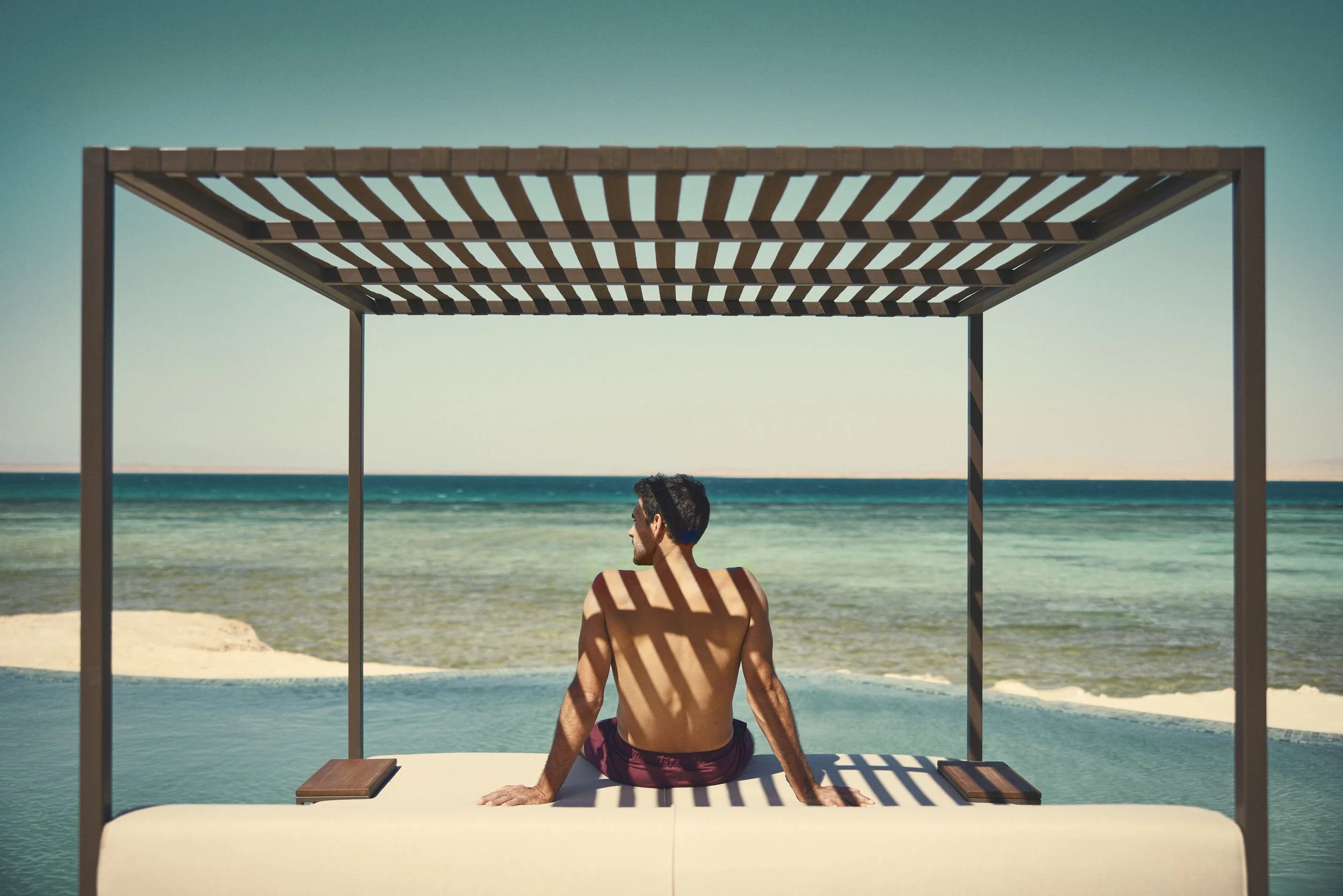 A guest looks out onto the Red Sea in this lifestyle image taken for the Saudi Neom project's Sindalah island