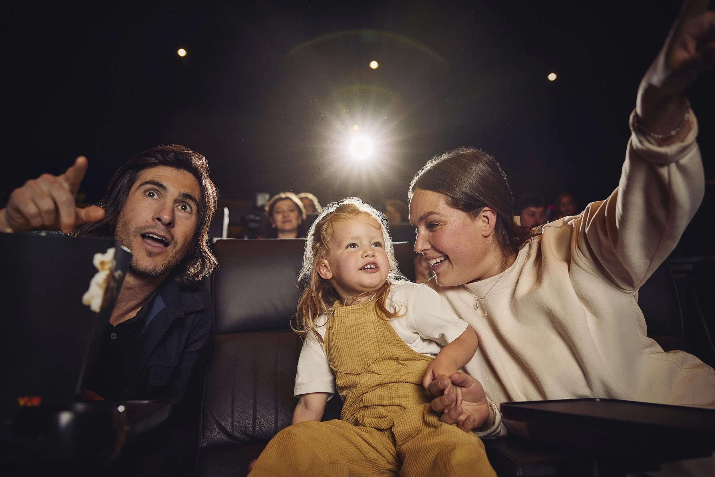 A young family are engrossed in a film in this lifestyle photography by London based advertising photographer Jon Enoch for leading cinema chain Vue