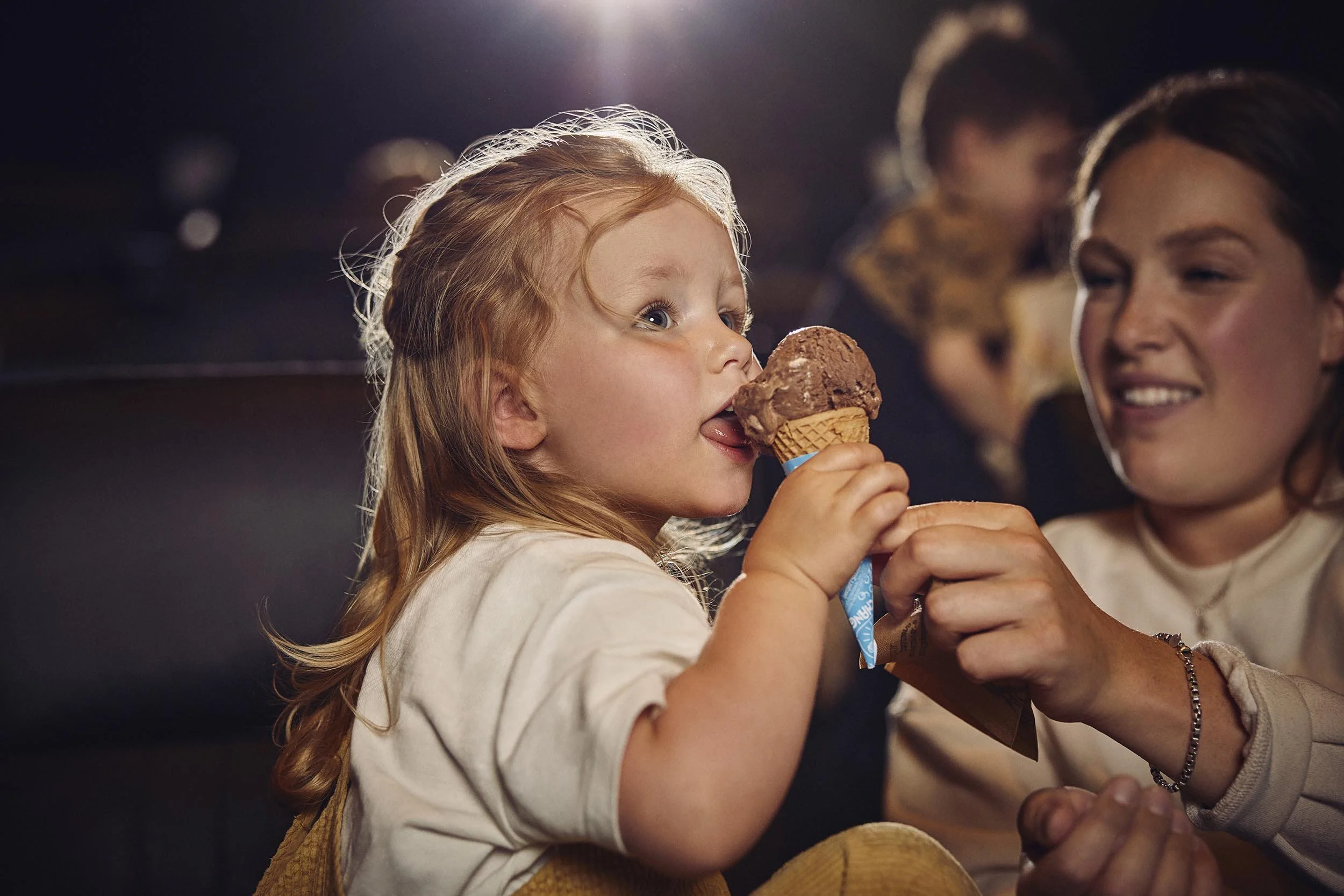 A child easts an ice cream in this lifestyle photography by advertising photographer Jon Enoch for leading cinema chain Vue