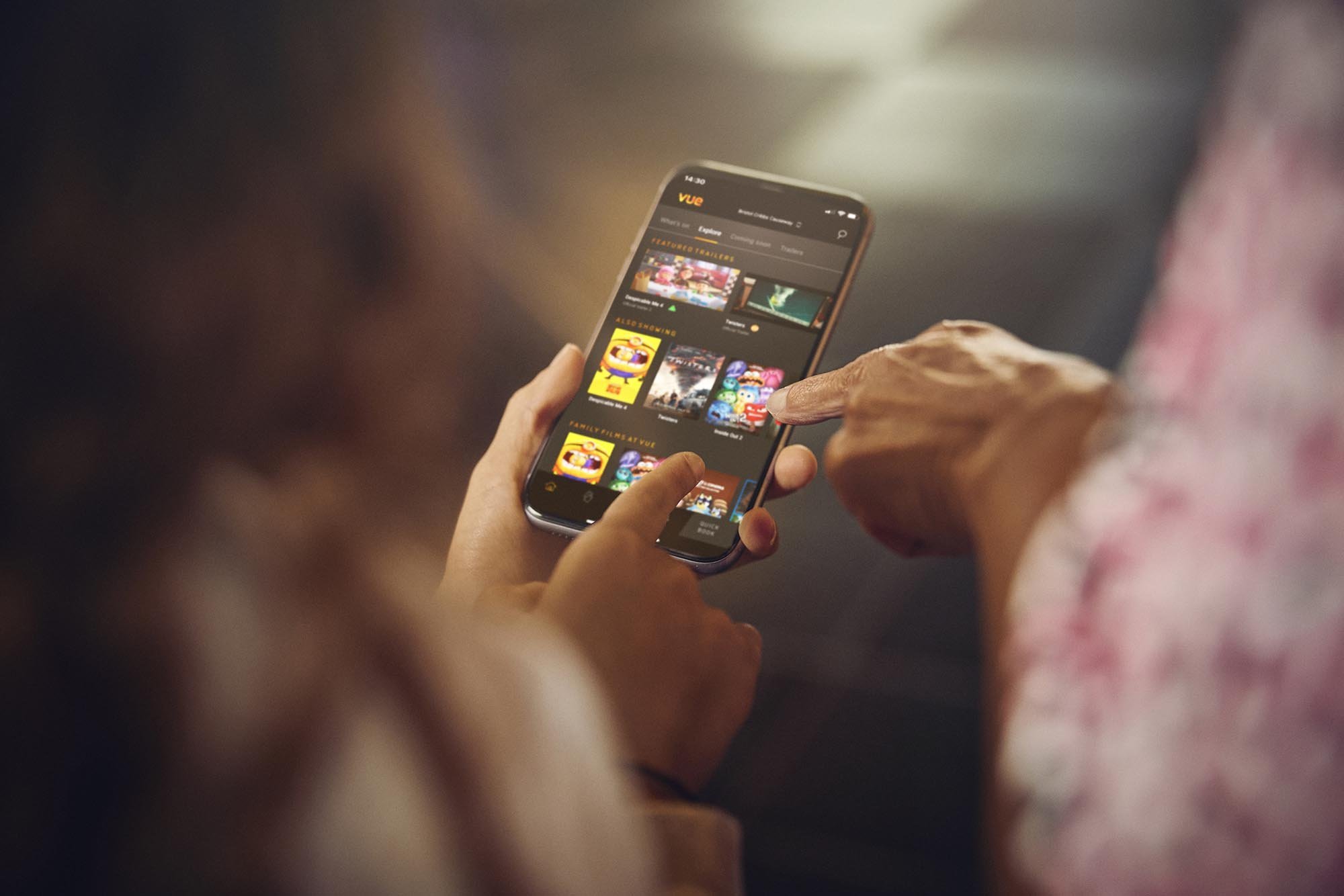 People use their smart phone to access the Vue app in this lifestyle picture shot by advertising photographer Jon Enoch