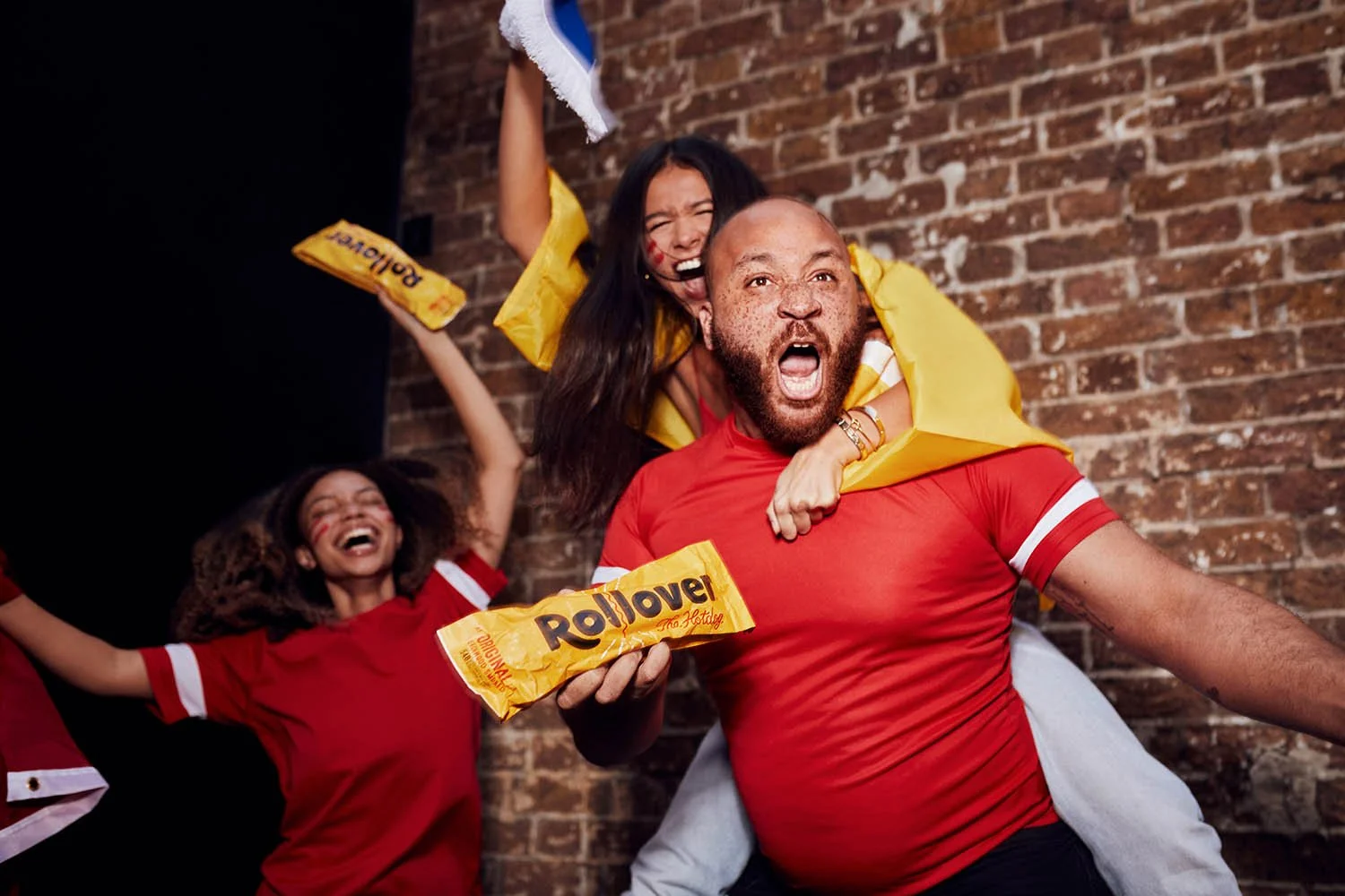 A group of football fans celebrate. Lifestyle image taken by advertising photographer Jon Enoch.