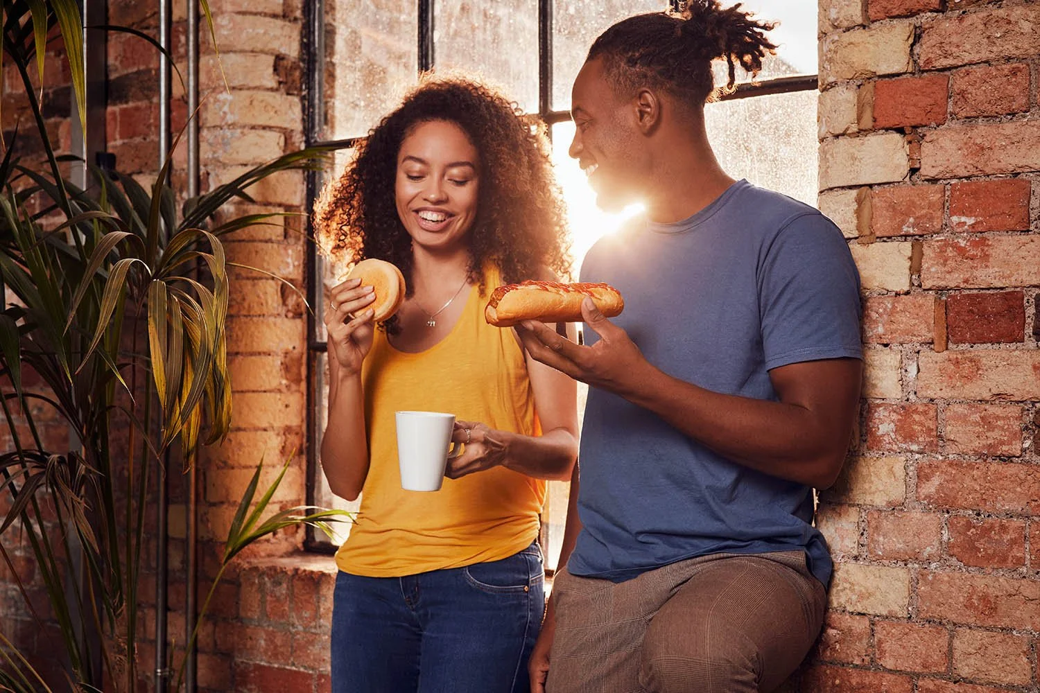 A couple chat over breakfast as the sun rises in London. Lifestyle photographer Jon Enoch captures this relaxed moment.