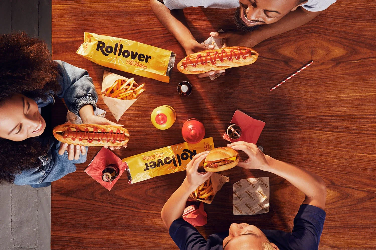 A table top, overhead view of a group of friends eating a meal.