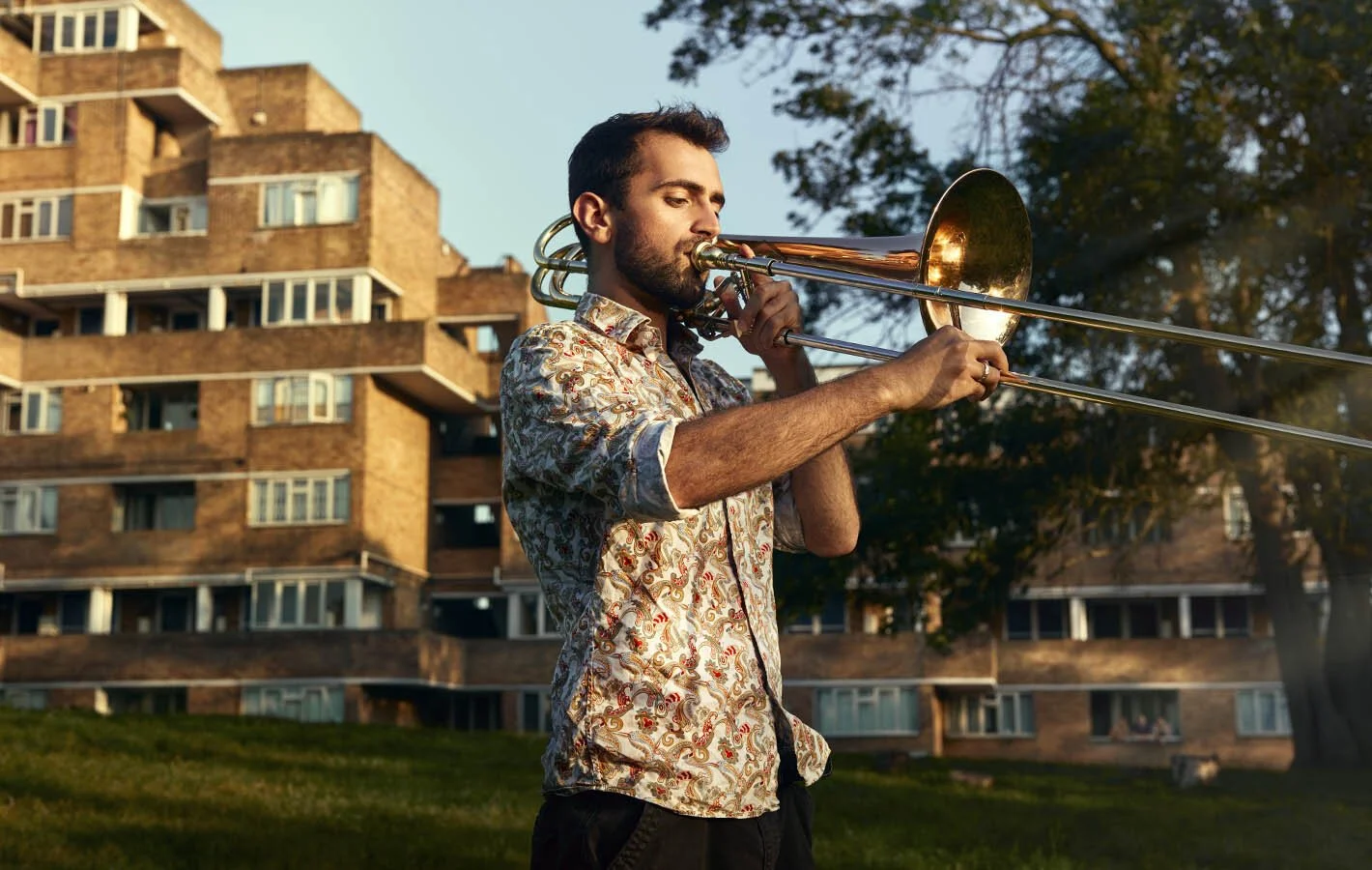 Rehearsal Room by Photographer Jon Enoch. Pictured: Yusuf Oliver Narcin and his bass trombone, East Dulwich, London.
