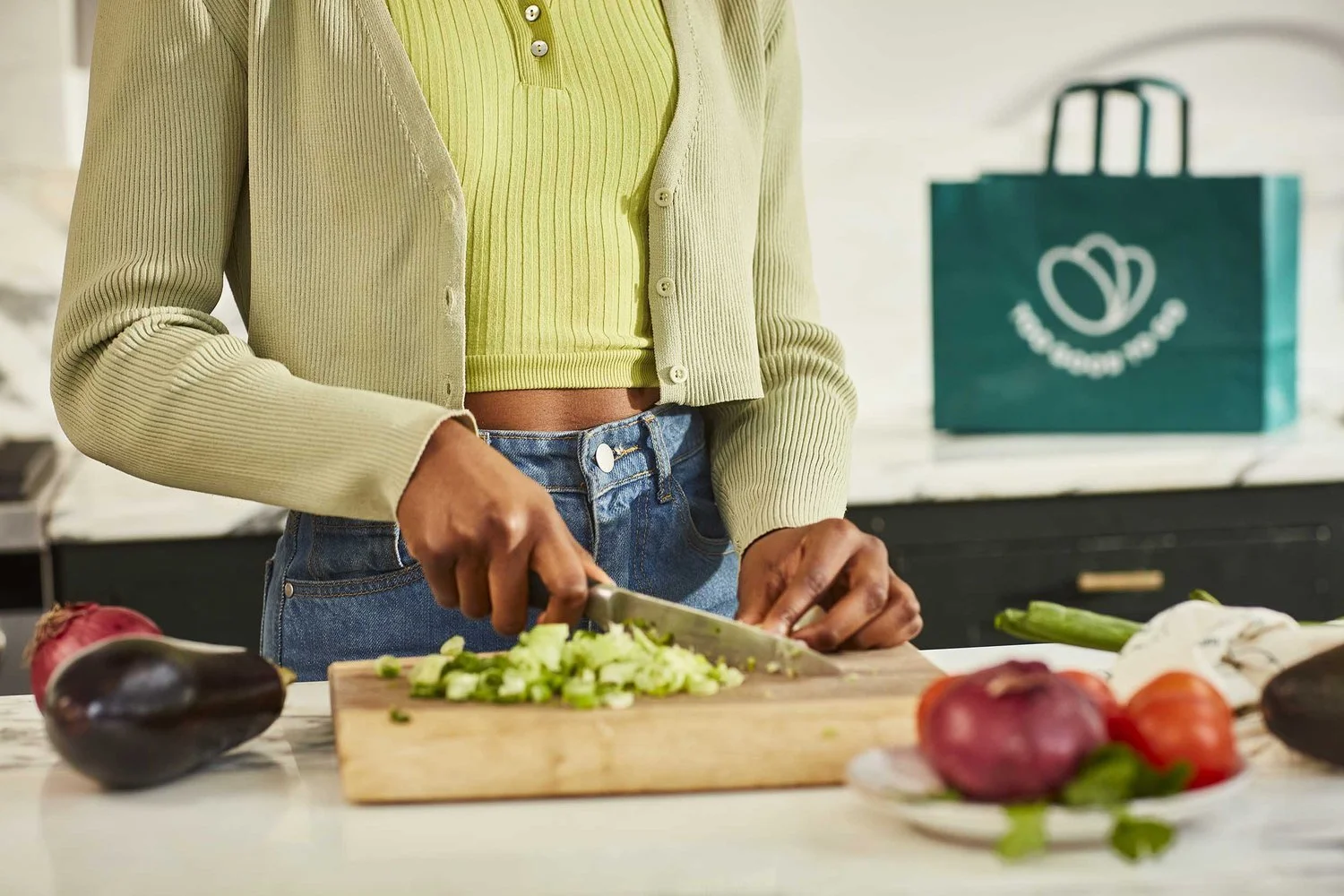 A young couple chat whilst preparing a healthy looking evening meal in this fresh bright lifestyle image by photographer Jon Enoch