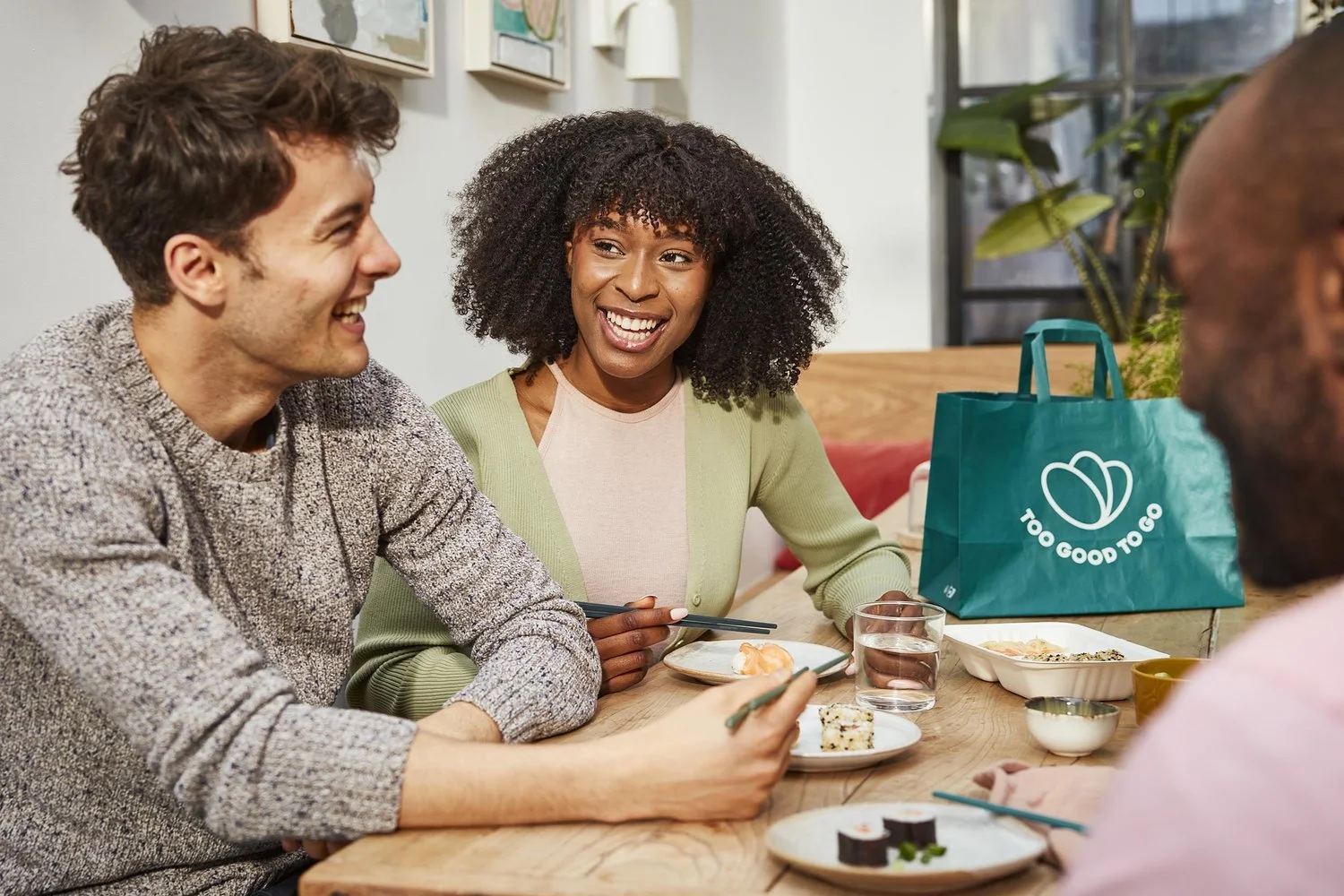 Friends chat at the kitchen table in this lifestyle image from London based photographer Jon Enoch