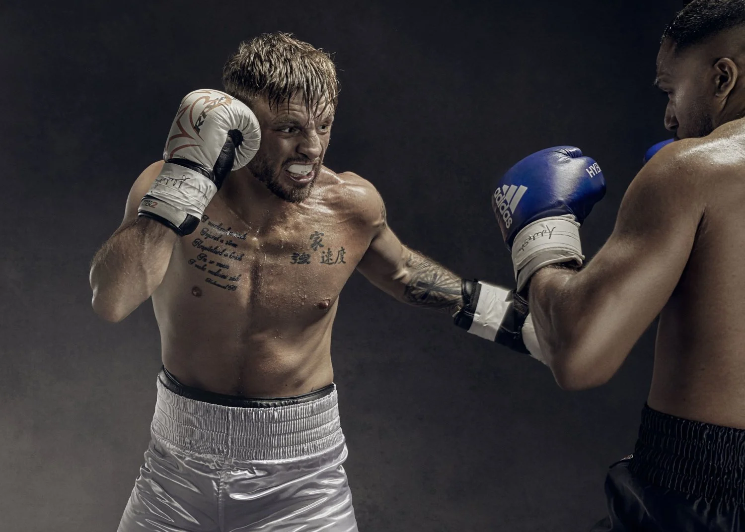 Two boxers in action in the ring in the stylising advertising image from sports photographer Jon enoch who works in the advertising, and lifestyle sectors