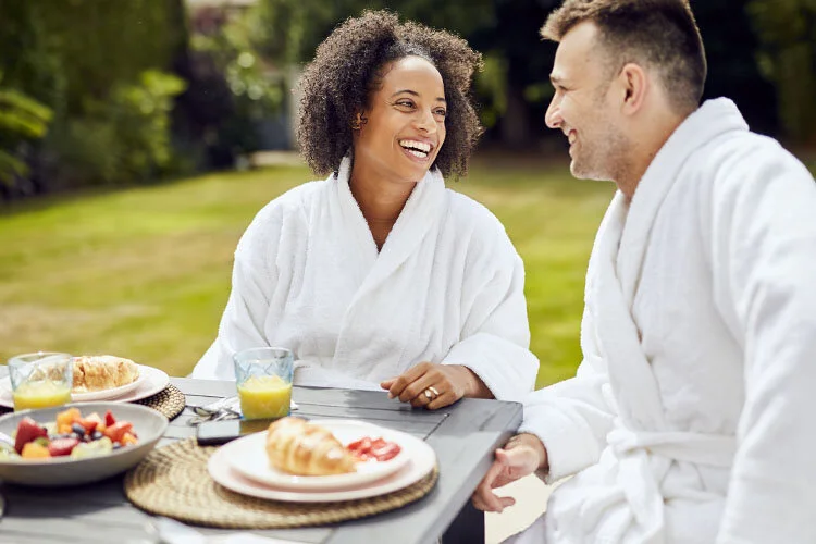 A couple enjoy breakfast outside in their garden. Lifestyle image by Jon Enoch