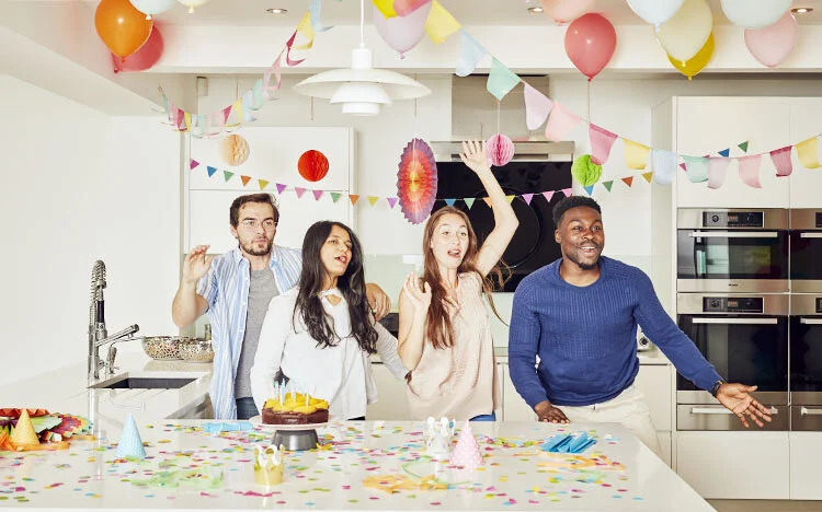 A group of friends hold a surprise party - lifestyle image by Jon Enoch.