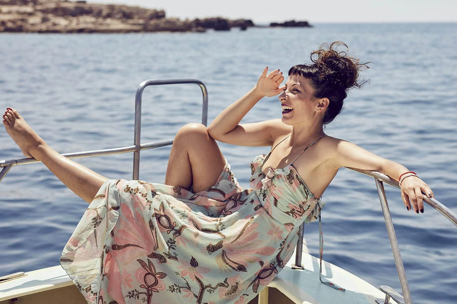 A women on a boat enjoy the seas around Croatia