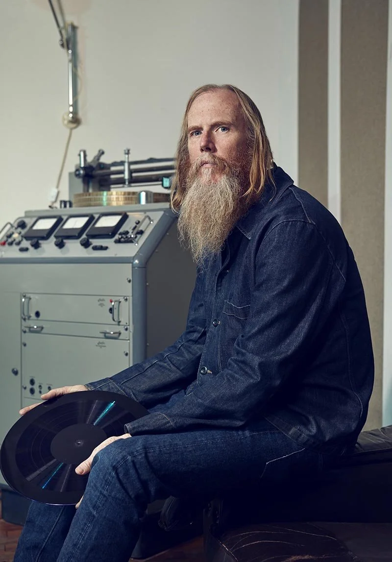 Portrait of Pete Hutchinson in his recording studio by photographer Jon Enoch