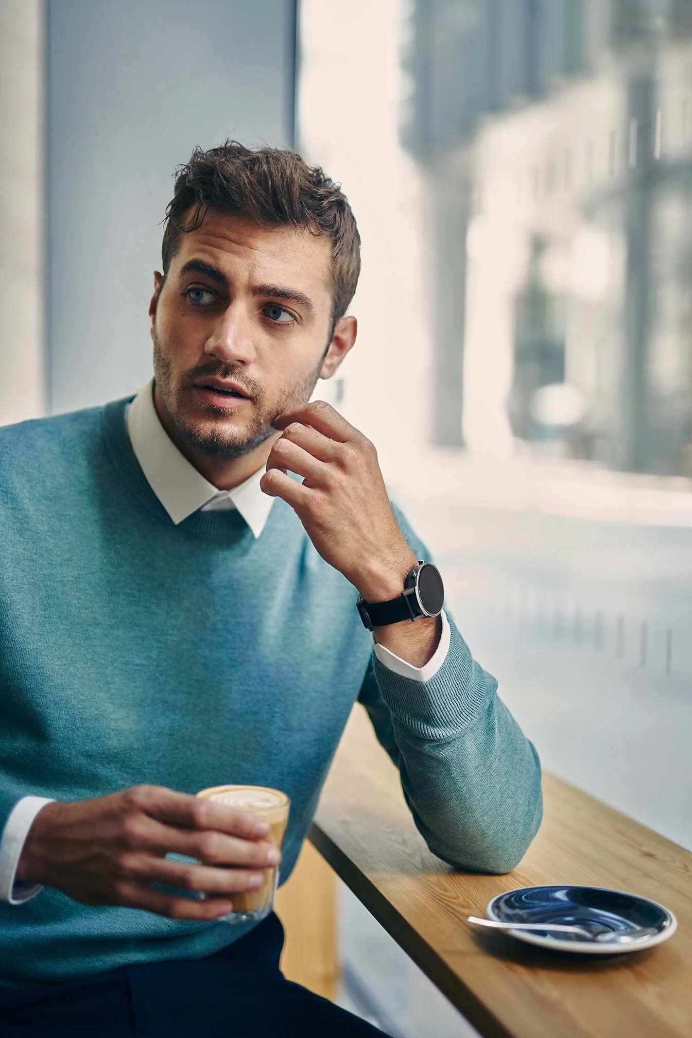 A man drinks a coffe in a coffee shop. Lifestyle photographer Jon Enoch.