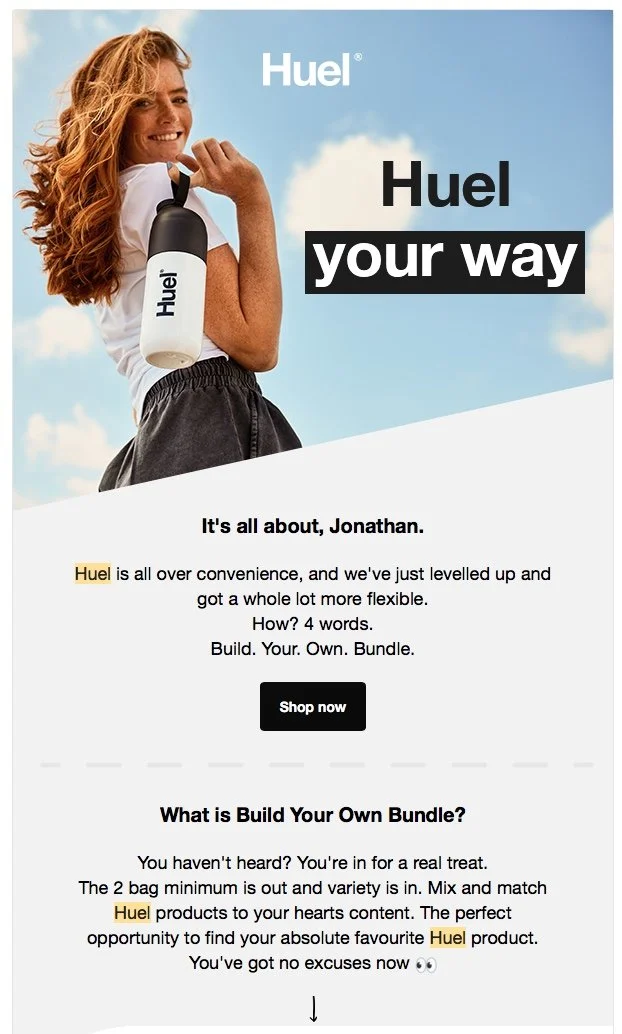 A young women holds a bottle of Huel whilst walking on a beach with clear blue skys in this lifestyle photography from Jon Enoch