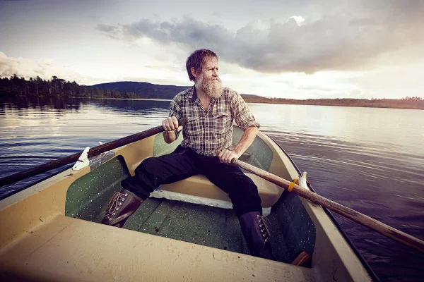 A man in a rowing boat in Norway photographed by lifestyle photographer Jon Enoch