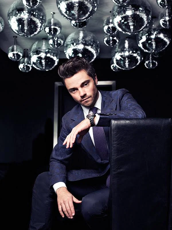Actor Dominic Cooper pictured in a dark suit by advertising photographer Jon Enoch.