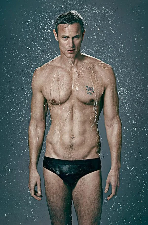 Swimmer Mark Foster pictured by sport advertising photographer Jon Enoch. The image shows Foster in a pair of trunks covered in water.