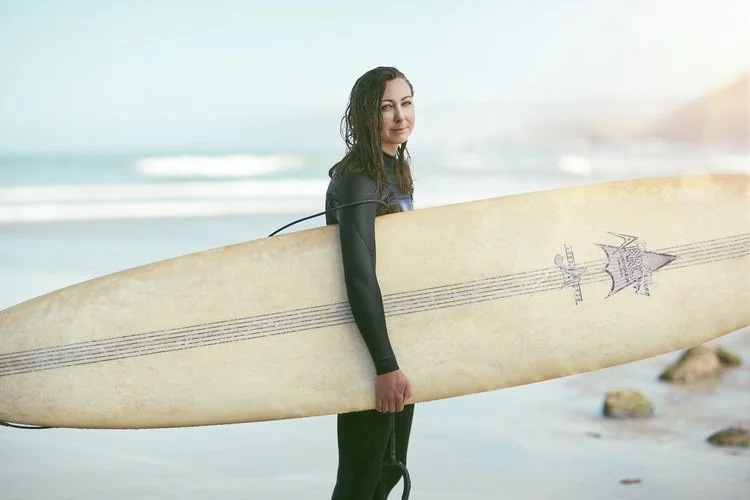 A female surfer pictured on the beach in California. Picture by lifestyle photographer Jon Enoch.