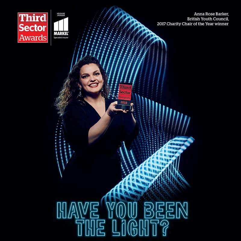 A women is surrounded by blurs of light. Studio portrait by advertising photographer Jon Enoch.