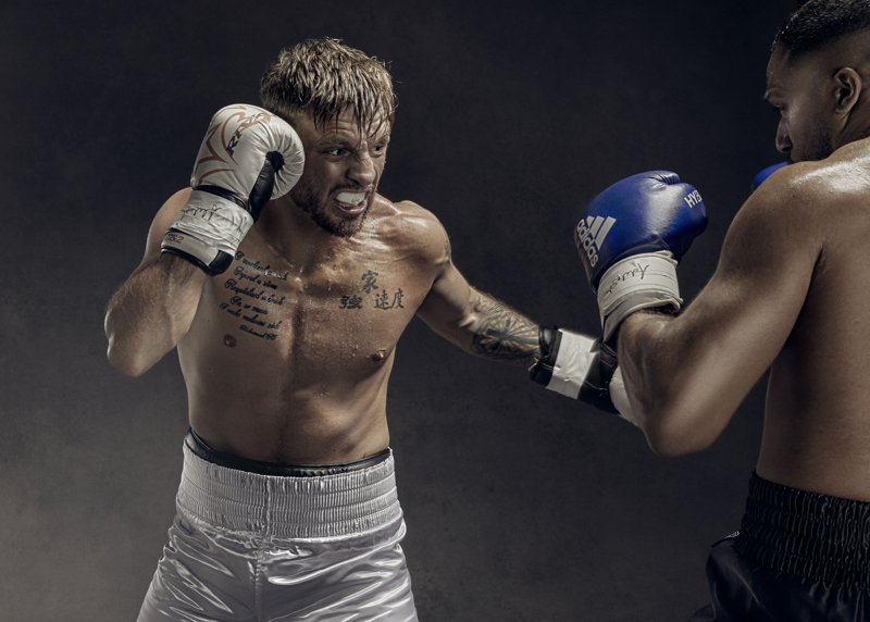 A boxer throws a left hook in the advertising photography shot by Jon Enoch