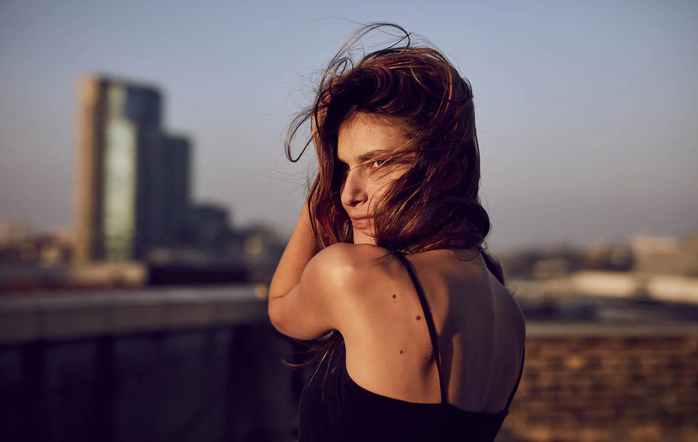 A women enjoys the setting sun in the image by lifestyle photographer Jon Enoch  (Copy)