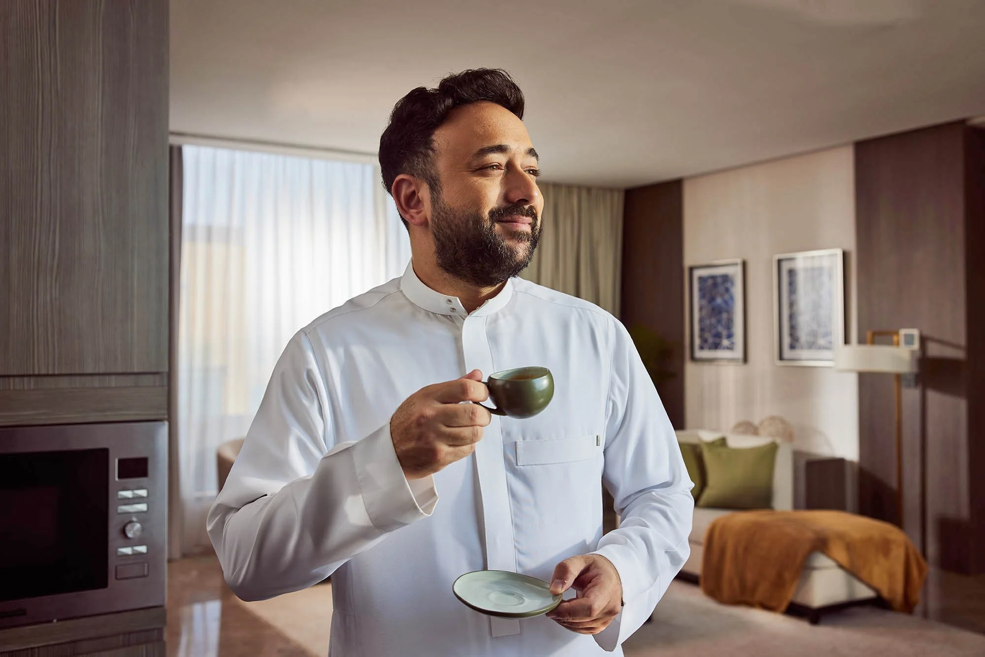 Actor Yasir Alsaggaf enjoys a coffee in this advertising image by Jon Enoch shot for Saudi Arabia's NHC.