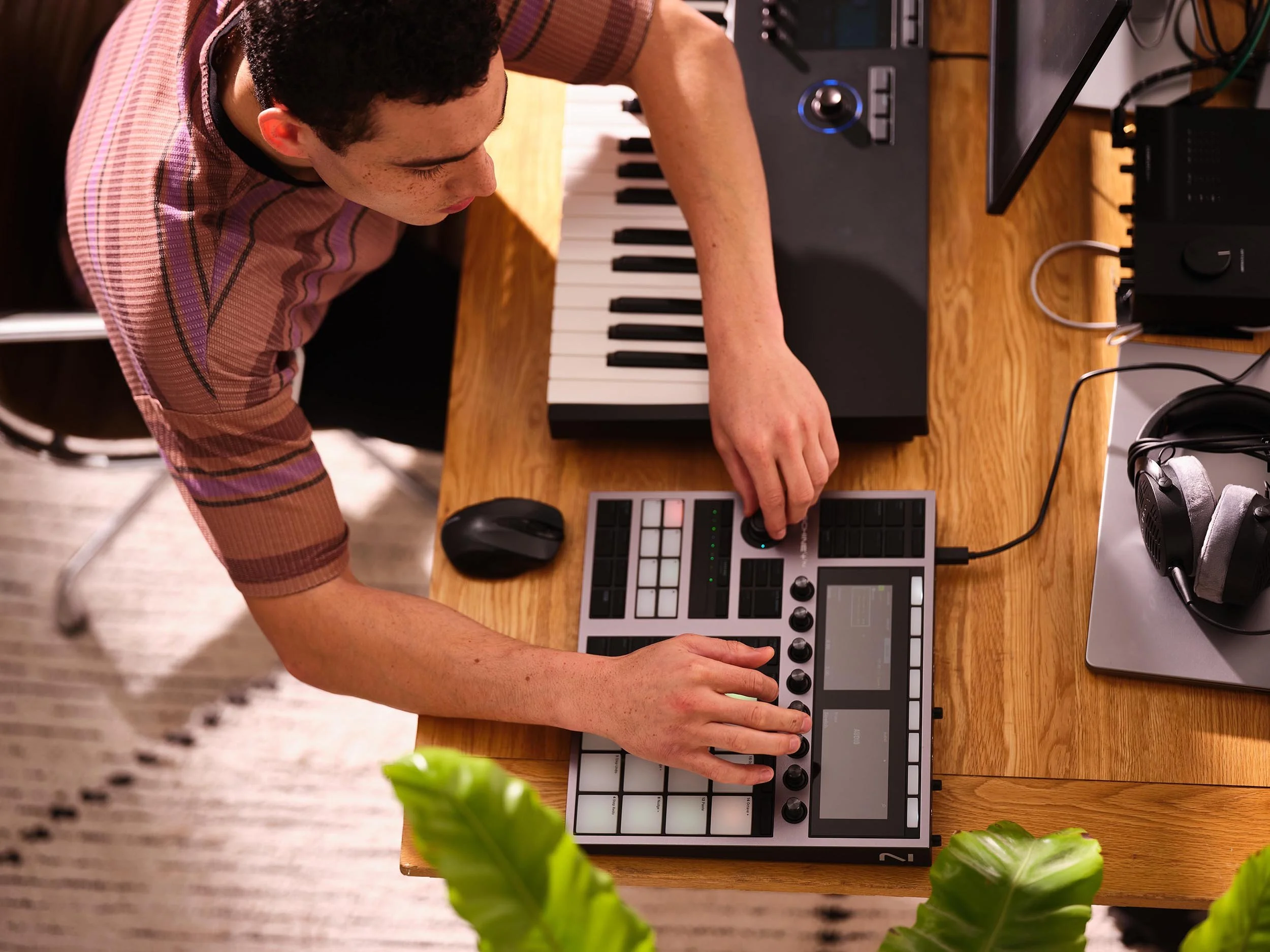 Advertising image shot by London based photographer Jon Enoch showing a musician using and playing Native Instruments software and hardware which are used for music production, sound design, performance and DJing
