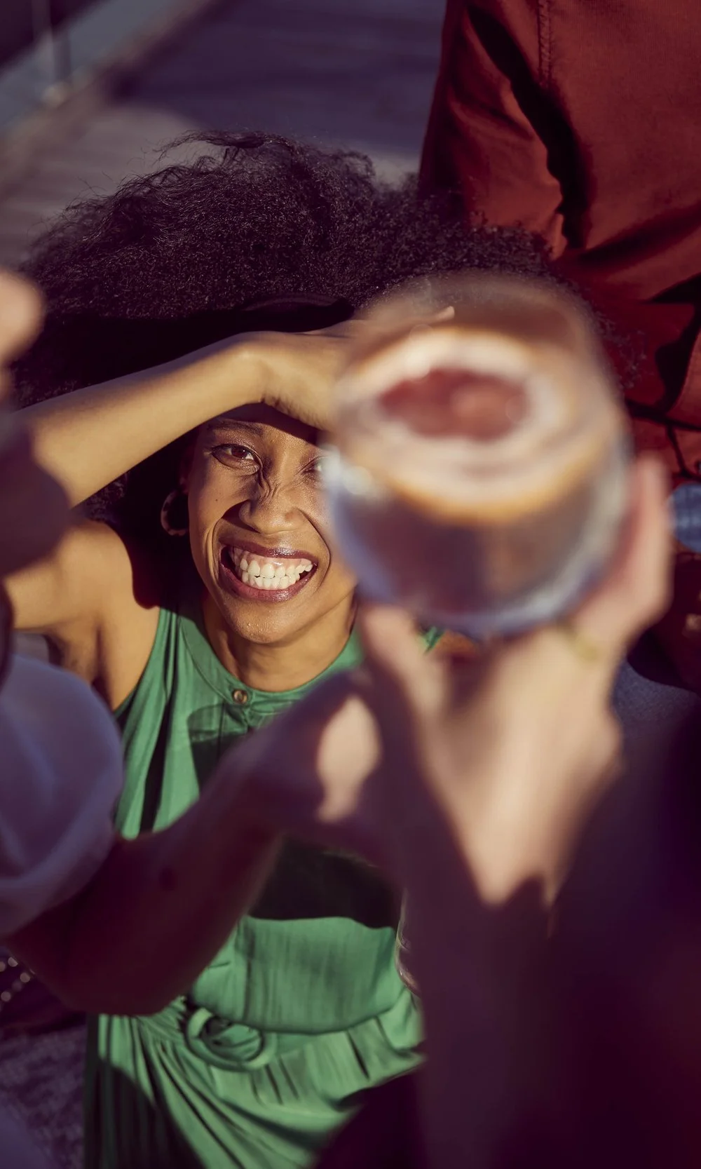 Friends laugh and enjoy each other's company with a few summer drinks in this lifestyle shot by Jon Enoch.