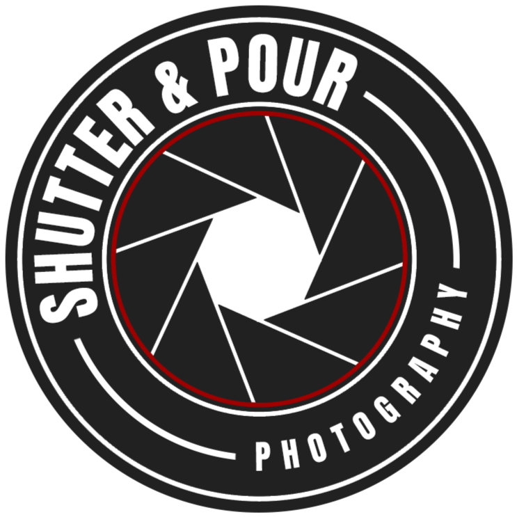 A circular logo with a camera shutter graphic in the center. The text around the logo reads 'Sautier & Pour Photography'.