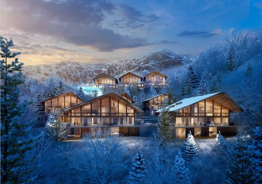 Conjunto de casas de madera en una zona montañosa cubierta de nieve, iluminadas desde su interior, en un paisaje invernal al atardecer.