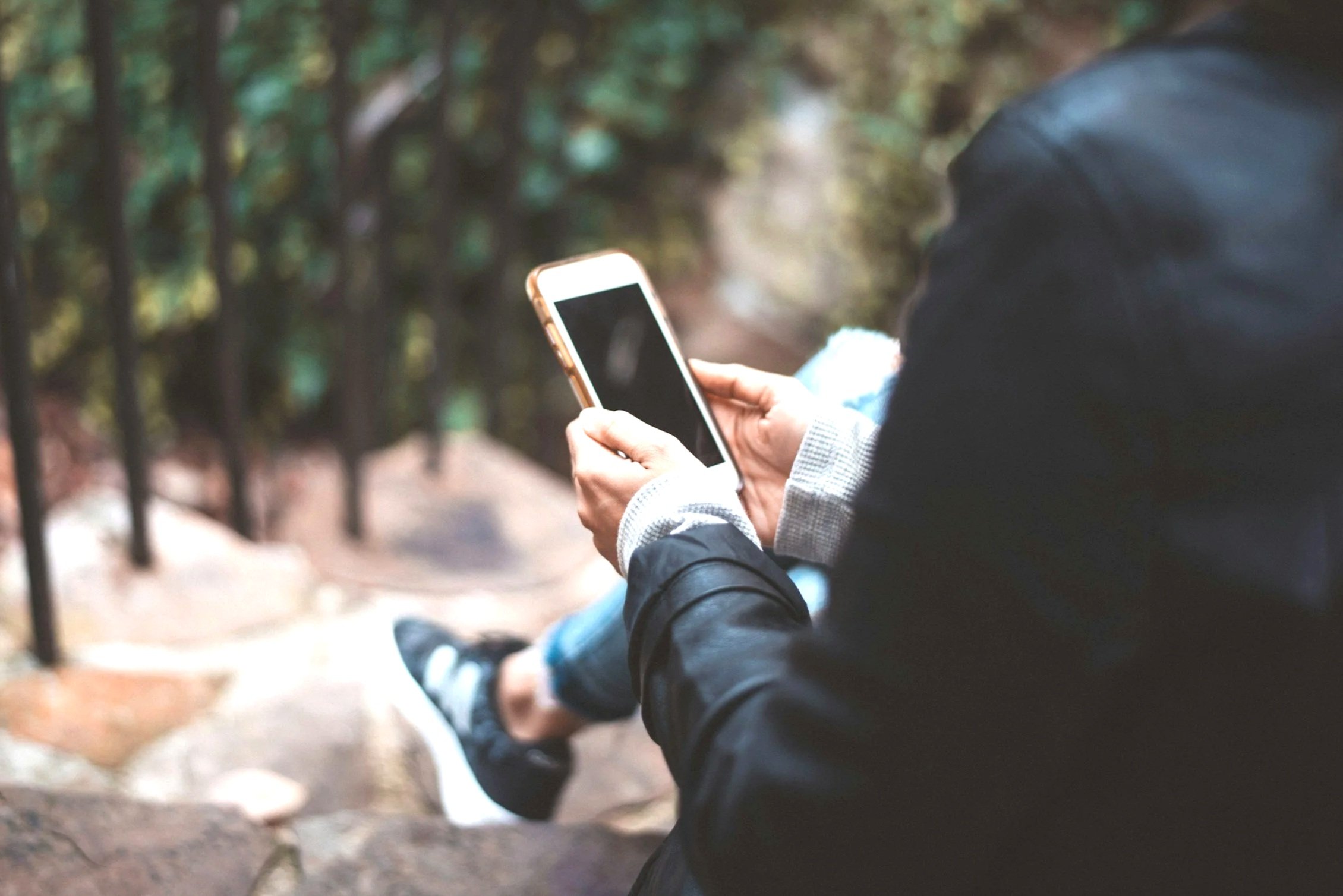Woman using a smartphone to contact Mosaic Virginia for medical services.
