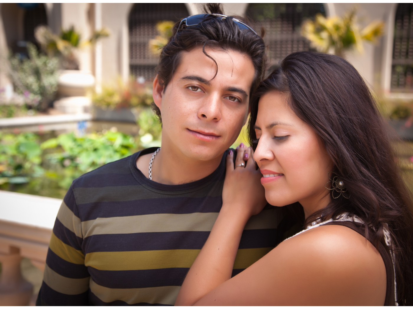 A young man and woman standing close together. Mosaic Virginia offers male mentoring to client partners.