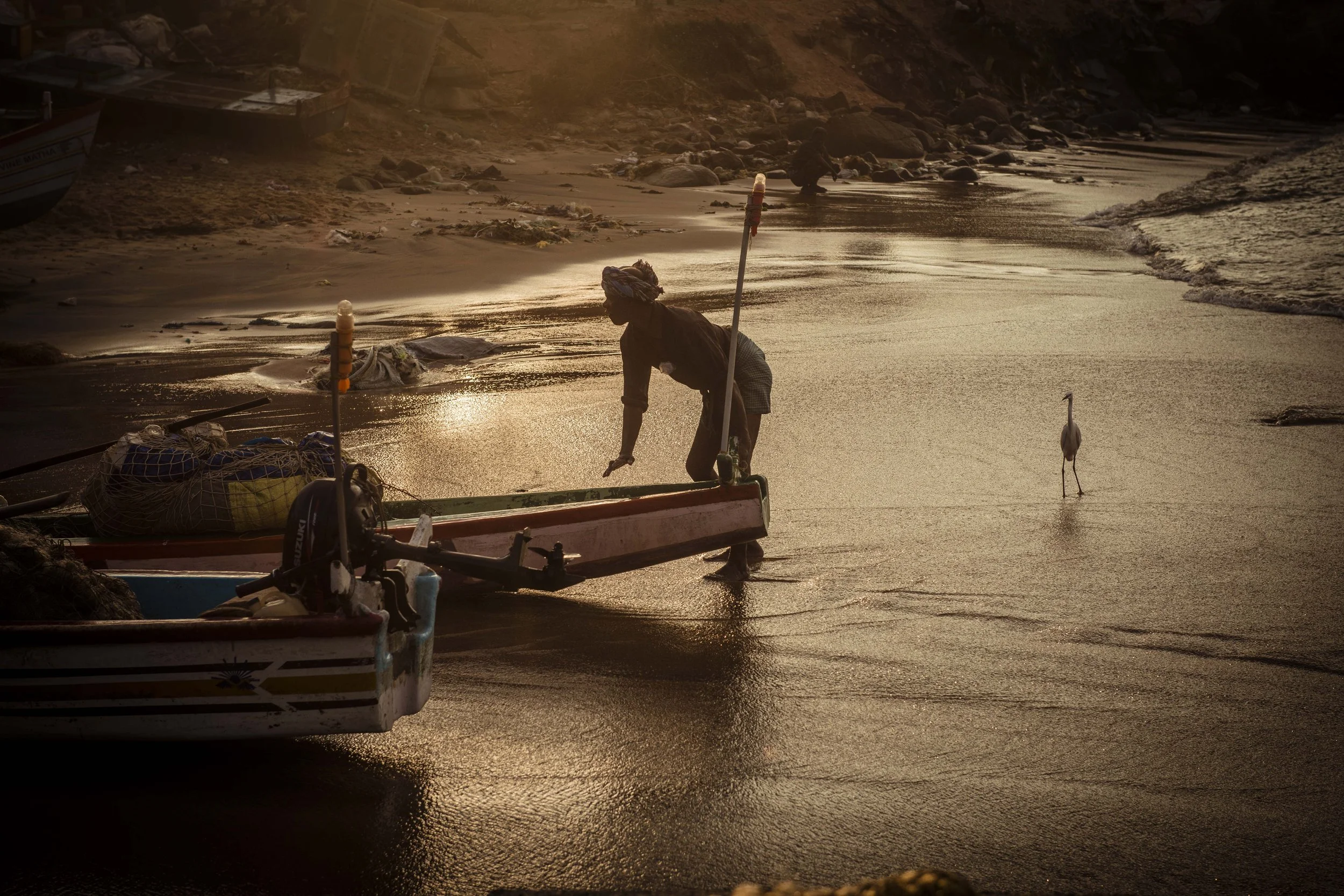 Dawn light silhouetting fisherman at Vizhinjam International Seaport Thiruvananthapuram