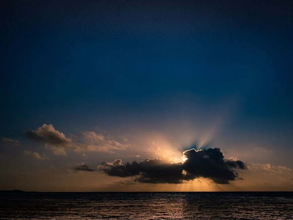 Sunset behind the clouds over the Pacific Ocean