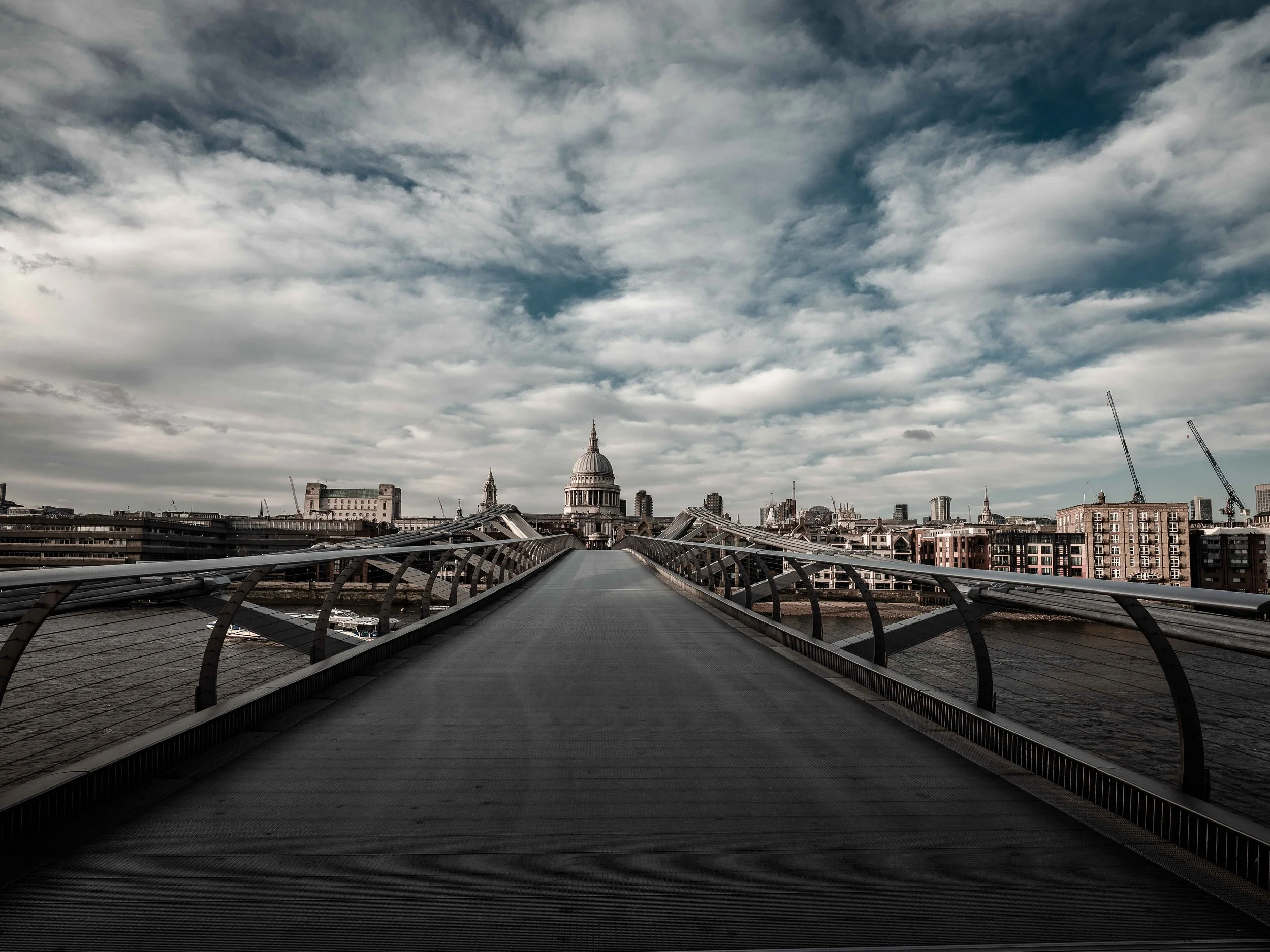 Deserted Millenium Bridge with St Paul's Cathedral, London during the afternoon in Lockdown