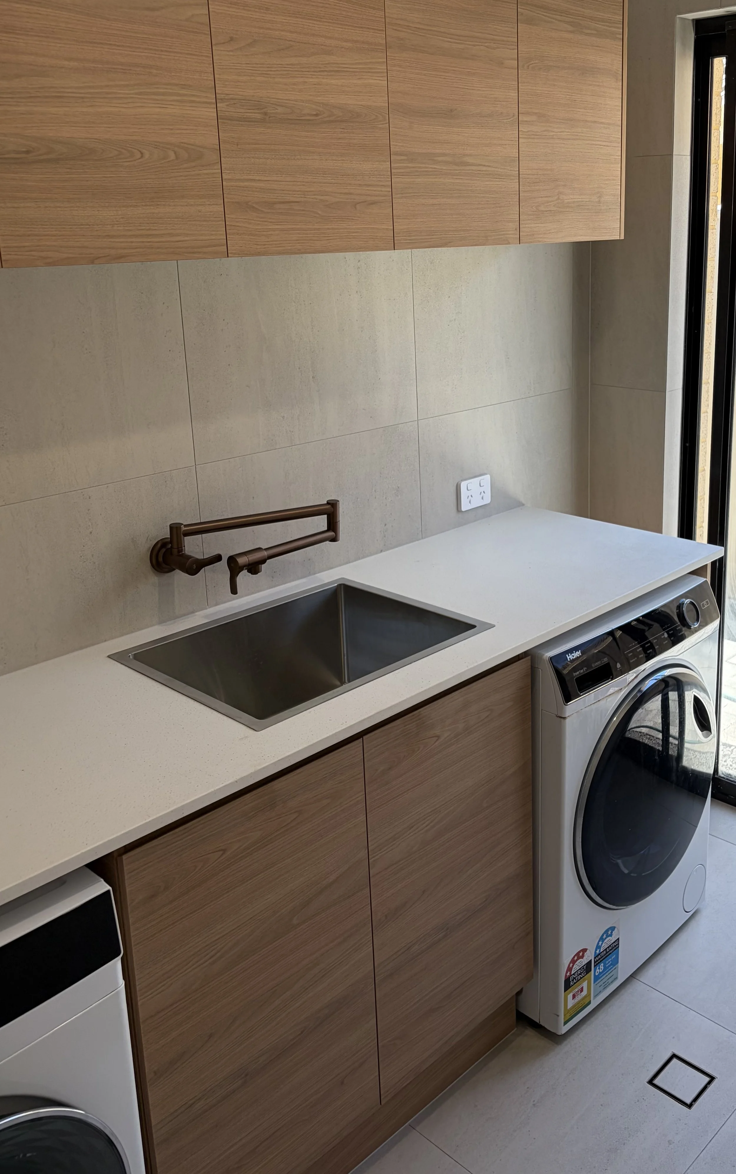 Laundry renovation by Graziani Tiling & Renovations (GTR Renovations) in Perth, showcasing wall tiling, functional cabinetry, and modern utility design.
