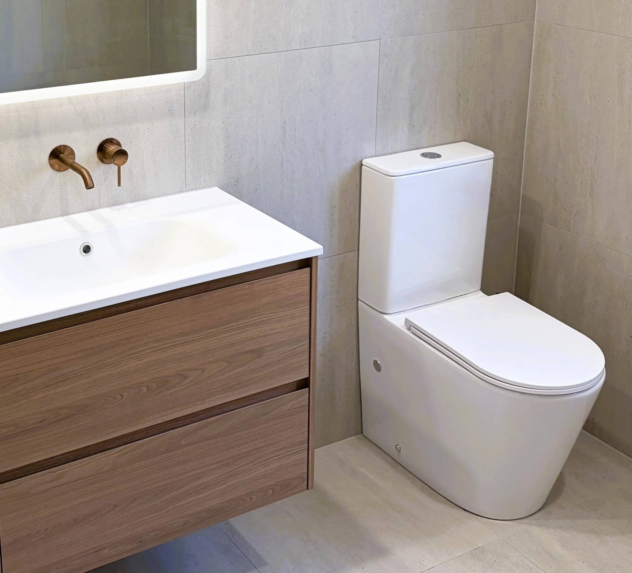 Bathroom renovation by Graziani Tiling & Renovations (GTR Renovations) in Perth, featuring a wall‑hung timber vanity, modern basin, wall‑mounted tapware, and precision tiling.