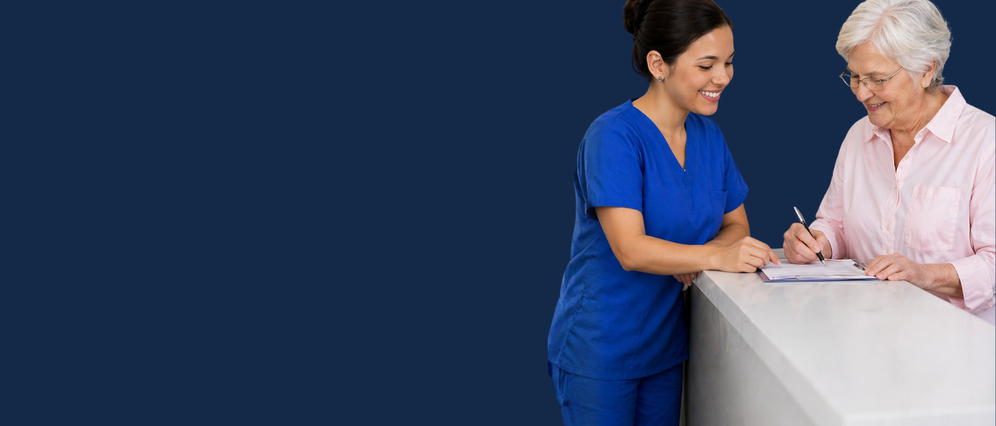 Frontdeskt helping patients with their insurace.