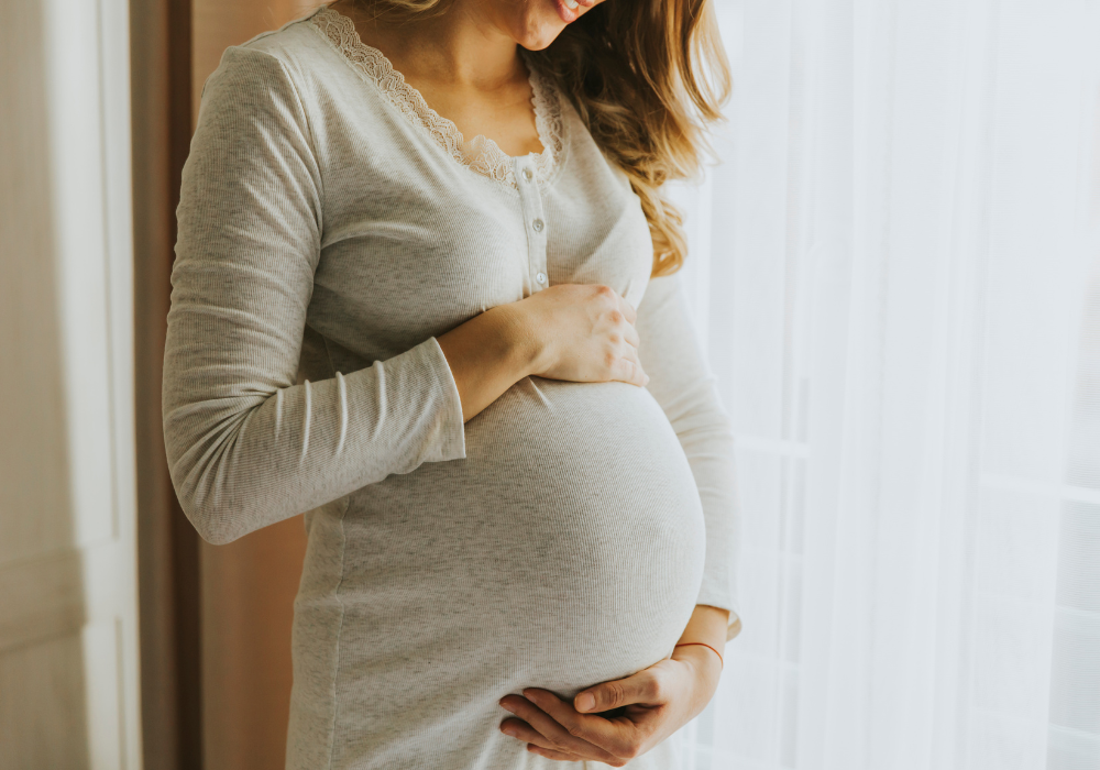This image shows a pregnant woman holding her baby bump.
