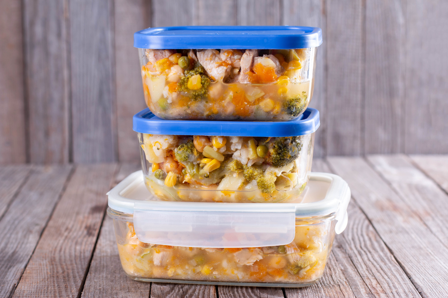 Labelled freezer-ready postpartum meal containers prepared by a perinatal nutritionist for new mothers