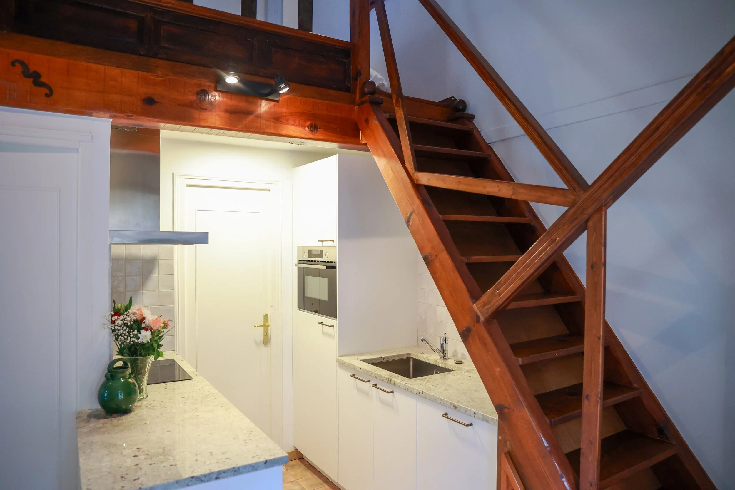 Cuisine équipée avec escalier menant à la mezzanine, Casa l’Ombria à Nonza, Cap Corse