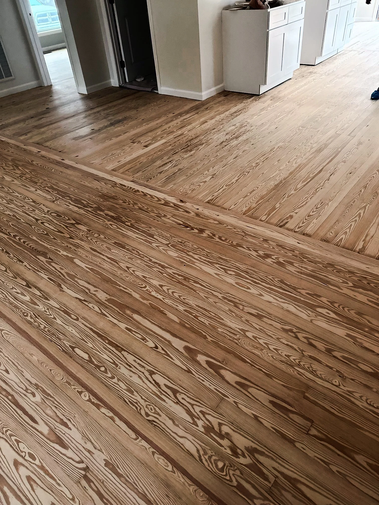 Providence Hardwood Flooring showing their expert craftsmanship with this 1920 solid pine hardwood floor restoration