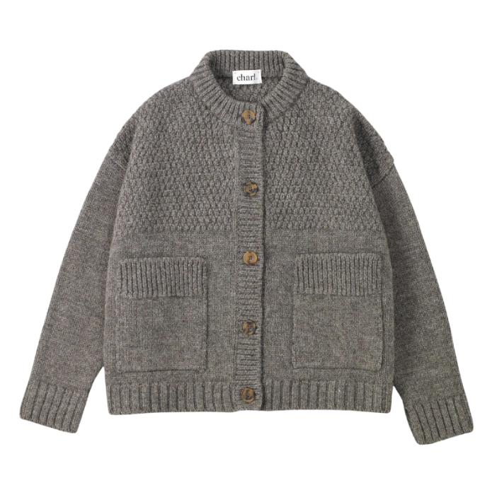 Charl - Betty Cardigan. Inspired by 19th-century Norfolk fishermen’s jumpers, this chunky crew-neck cardigan features roomy proportions, an original hailstone stitch, and oversized bucket pockets. Made from super-soft 100% British wool and knitted in