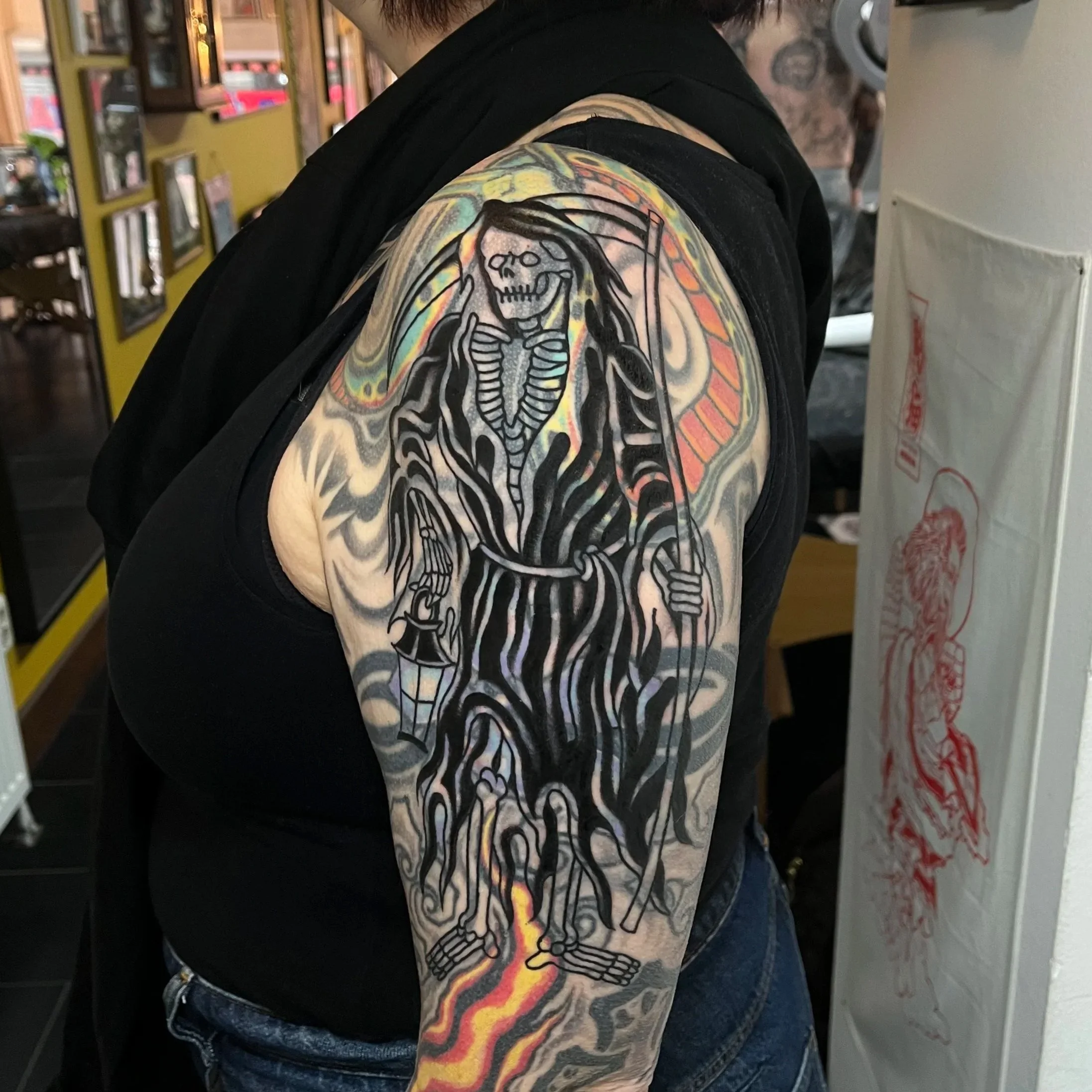 Tattoo of a grim reaper on colourful sleeve tattooed, the grim reaper is a blast over tattoo