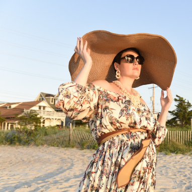 Woman on the beach wearing the Eddy Crane Maxi Dress designed by Mayes NYC