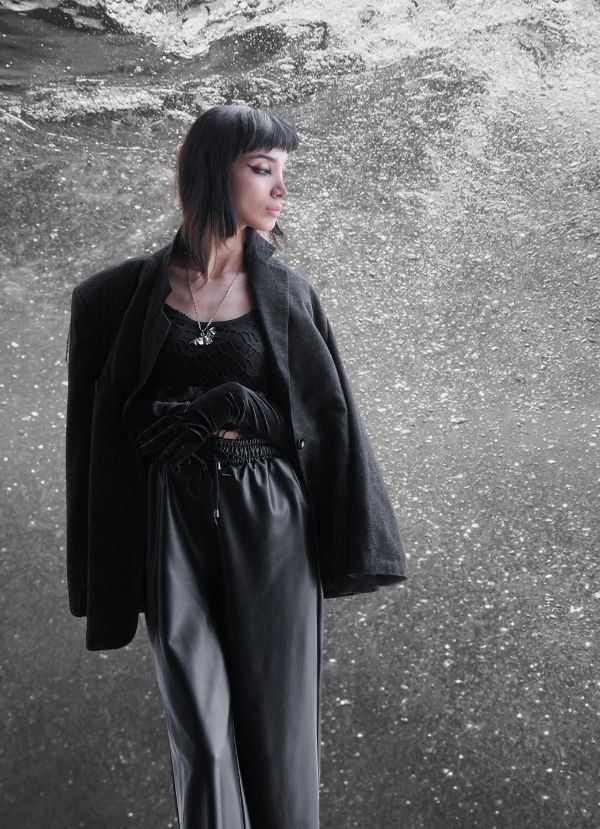 Communications model in black with water in the background