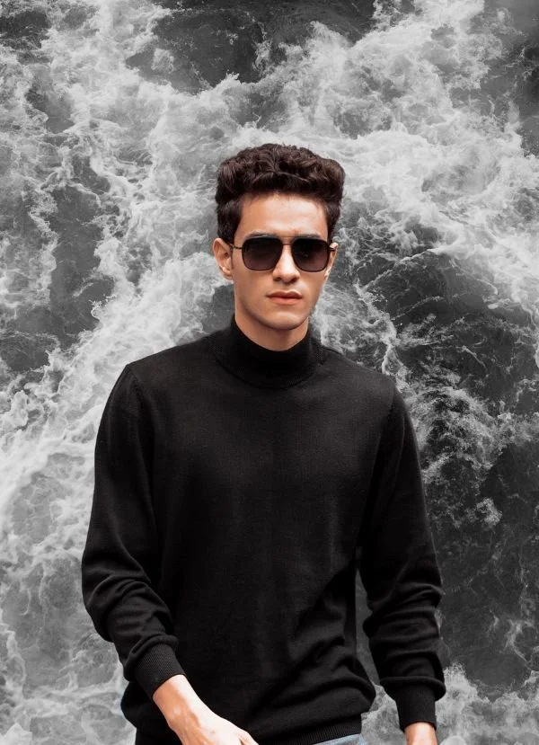 Marketing Design, model in a black polo shirt wearing sunglasses with water in the background