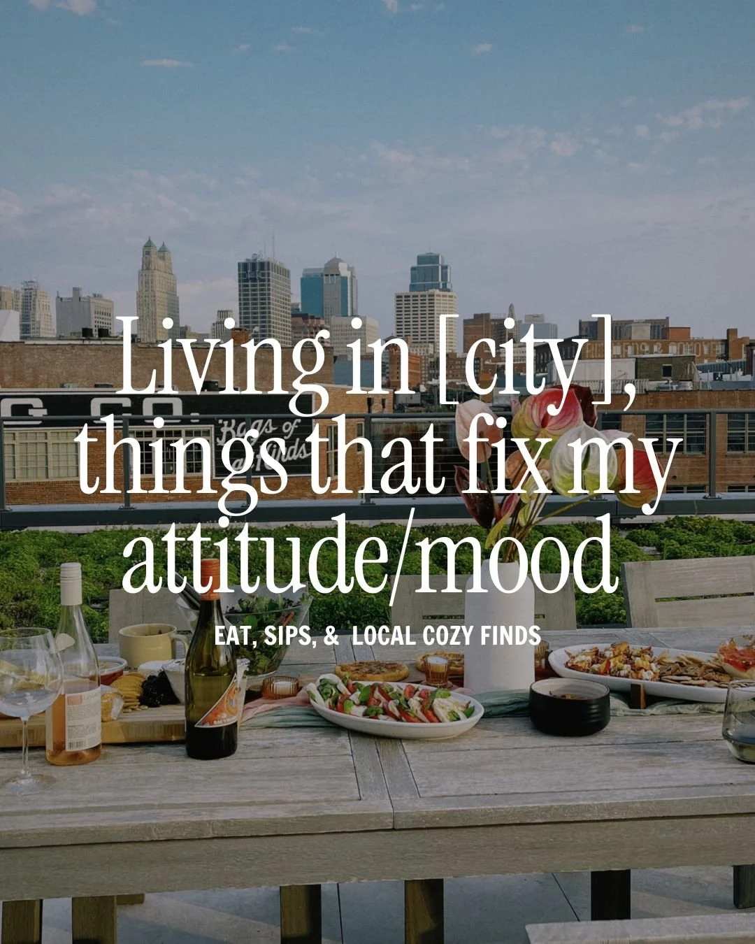 Outdoor rooftop dining table with food and drinks overlooking city skyline with tall buildings and partly cloudy sky.