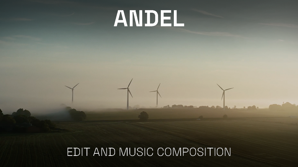 A landscape with four wind turbines on a foggy day over green fields