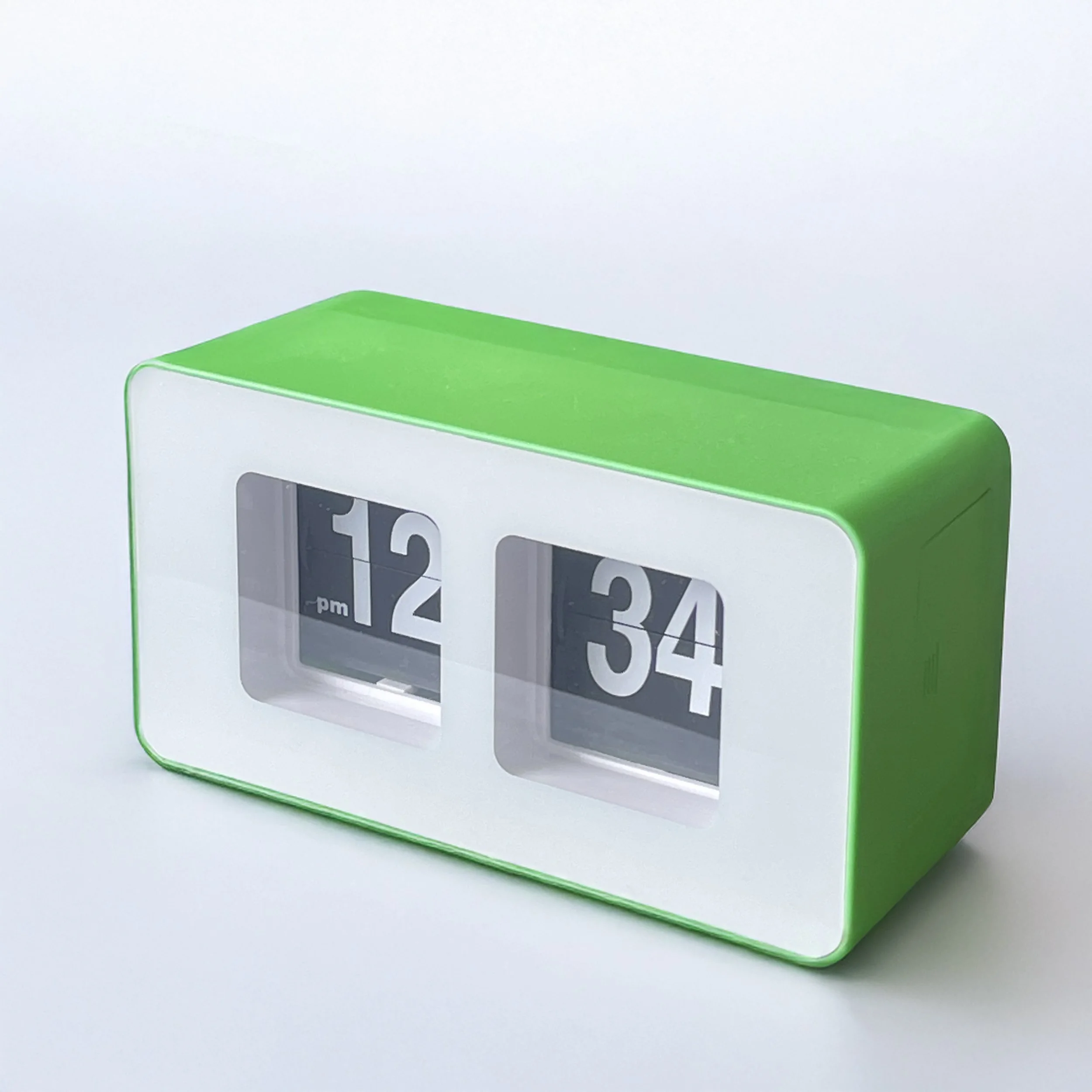 A green clock on a white background that reads 12:34